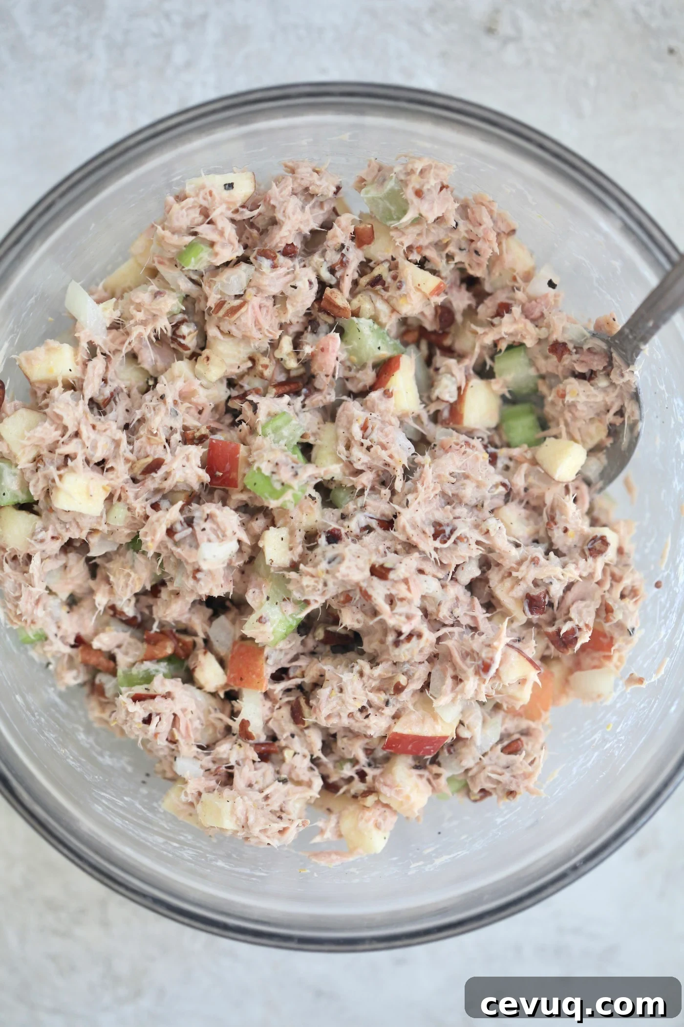 mixed up tuna salad in bowl with fork