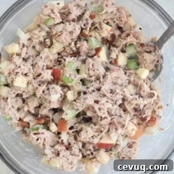 mixed up tuna salad in bowl with fork
