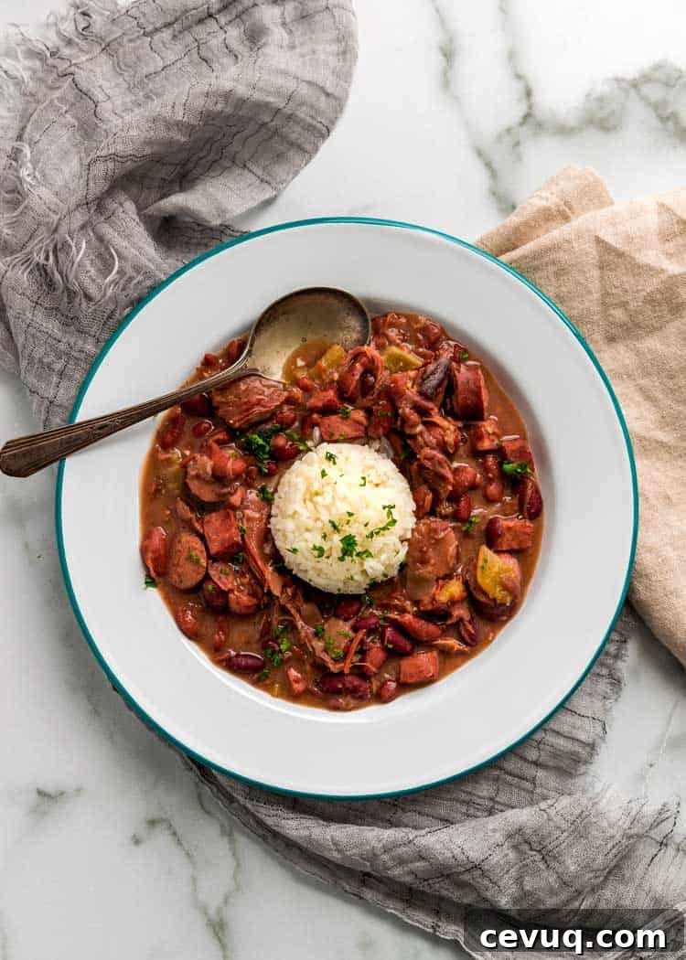 overhead: spoon in white bowl of instant pot red beans and rice