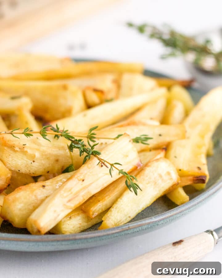 plate of parsnips with fork and thyme garnish