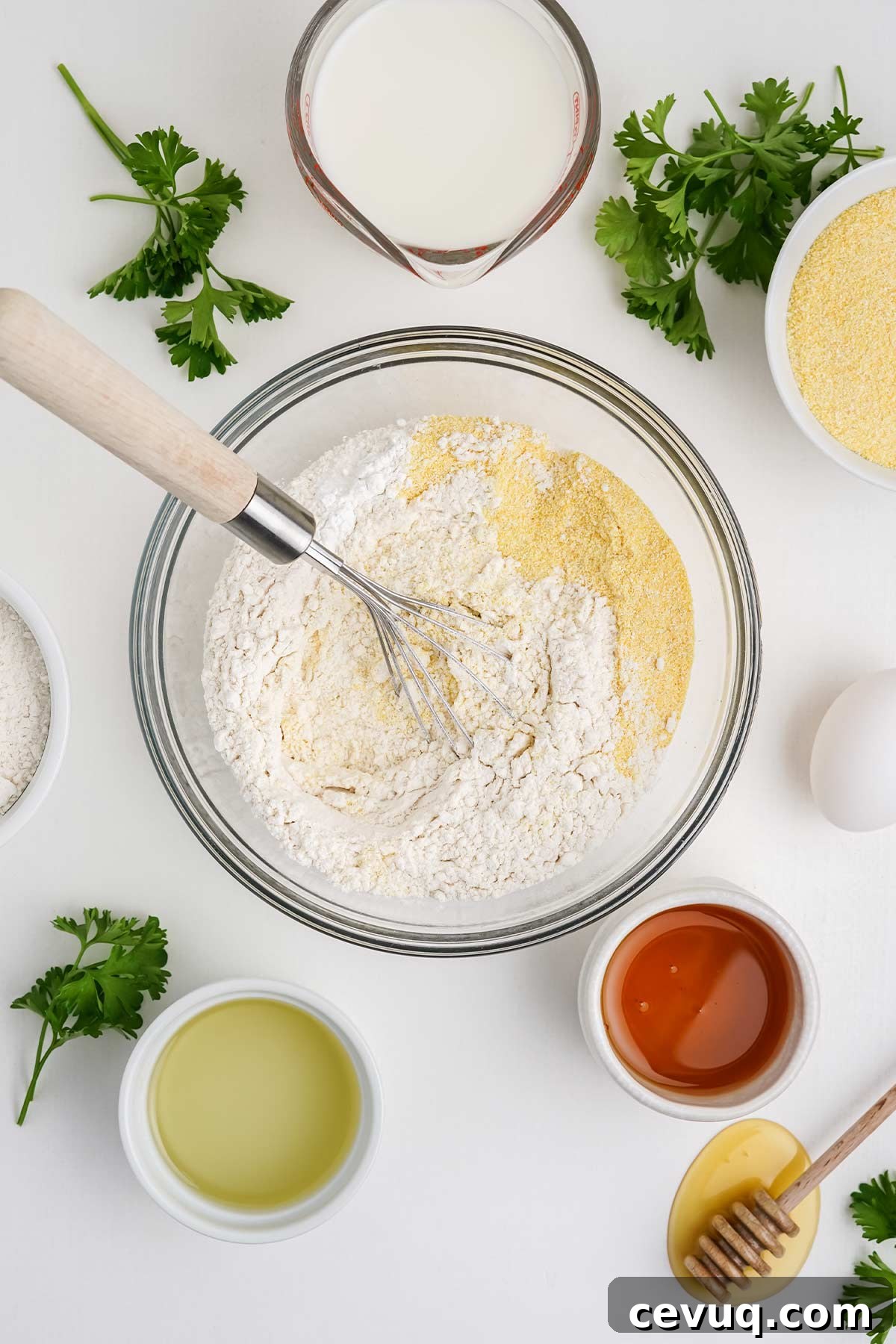 Mixing the dry ingredients for cornbread with honey.