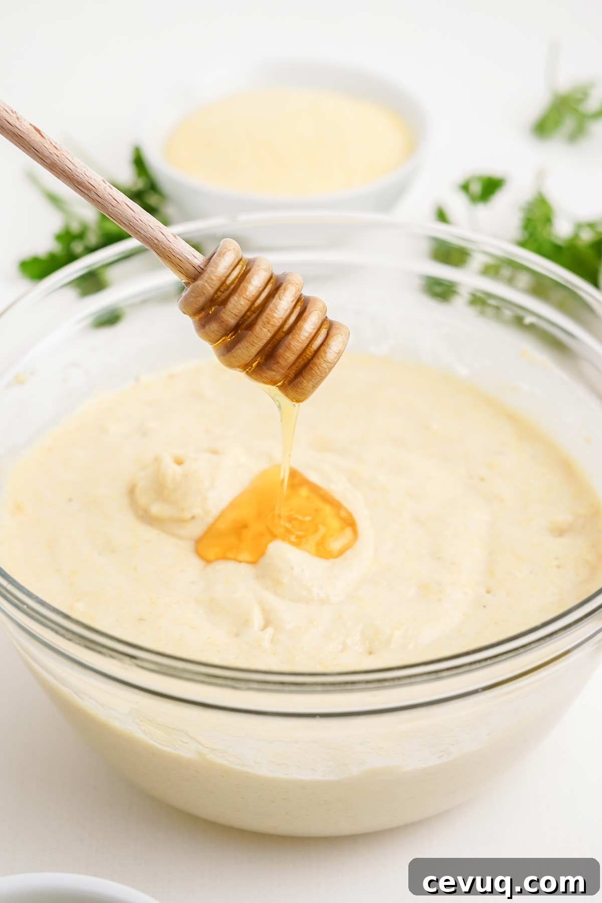Adding honey to the cornbread batter.