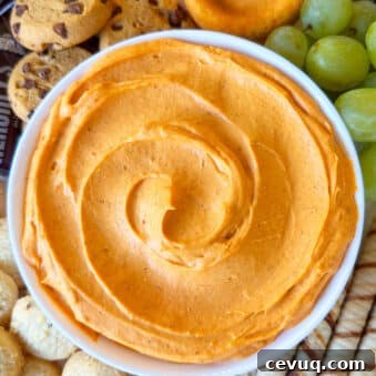Easy Pumpkin Dip in White Bowl on Tray With Cookies.