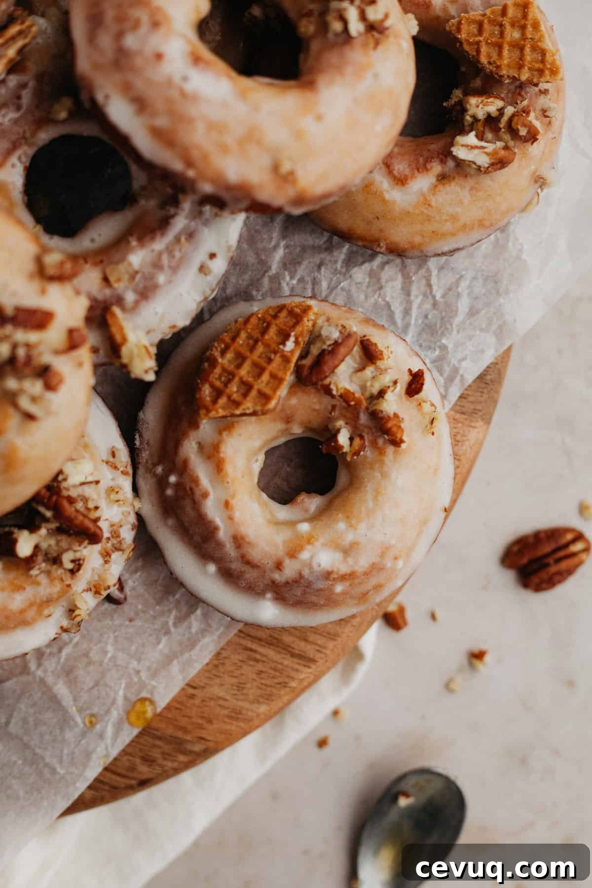 Glazed maple doughnuts on a wooden board