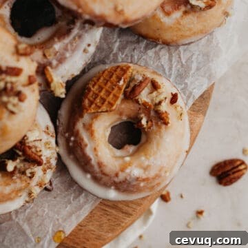 Glazed maple doughnuts on a wooden board