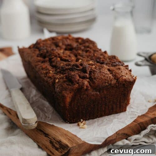 Cinnamon crunch banana bread loaf on a wooden board