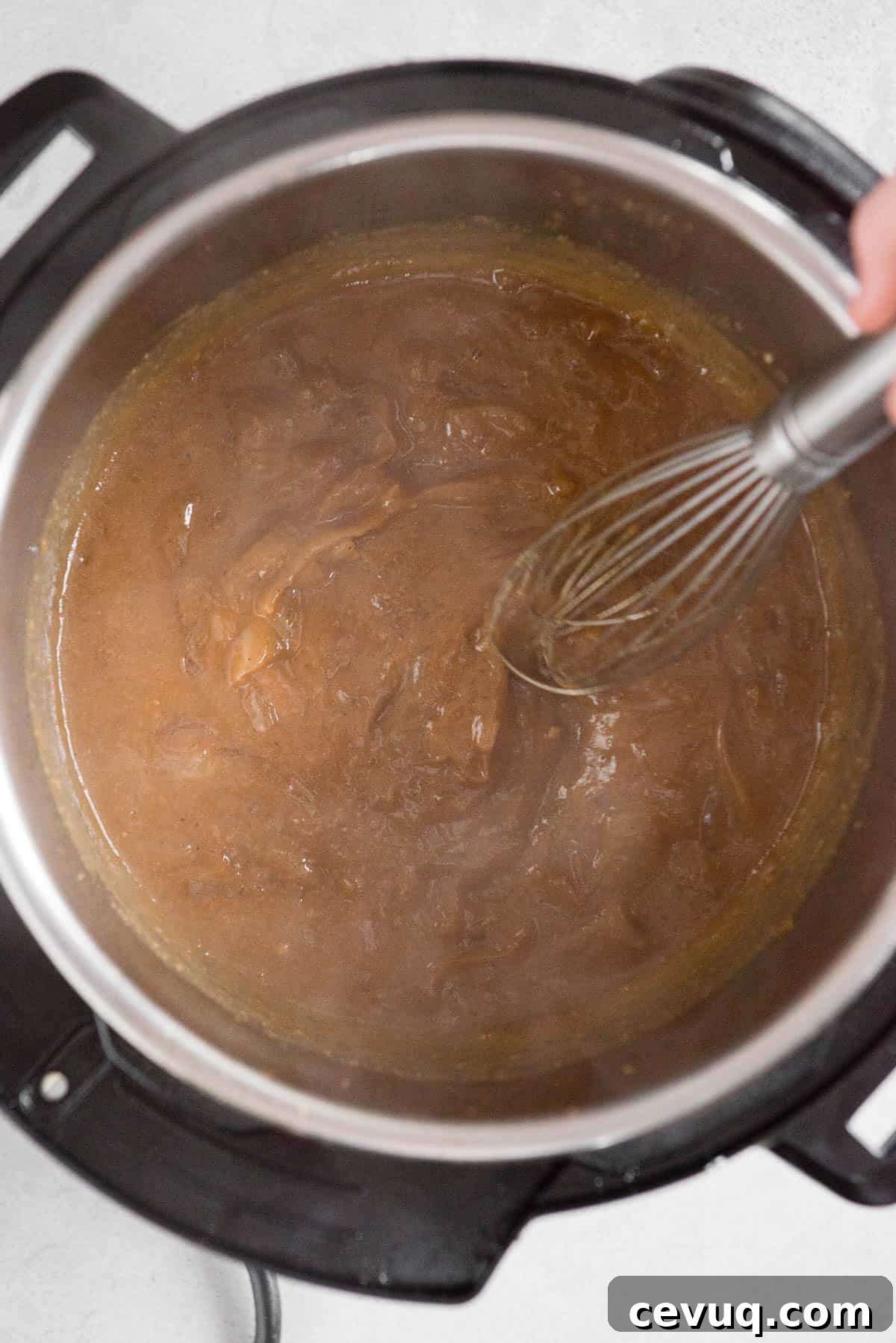 Juicy Instant Pot Pork Tenderloin Recipe for Quick Dinners 11 stirring onion gravy with whisk