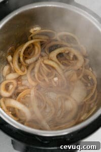 Juicy Instant Pot Pork Tenderloin Recipe for Quick Dinners 15 sautéed sliced onions in Instant Pot