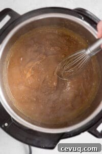 Juicy Instant Pot Pork Tenderloin Recipe for Quick Dinners 18 stirring onion gravy with whisk