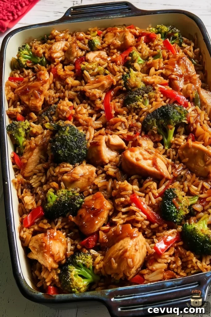 Teriyaki Chicken and Rice Casserole with tender chicken, broccoli, bell peppers, and fluffy rice baked in a sweet-savory homemade teriyaki sauce in a casserole dish.