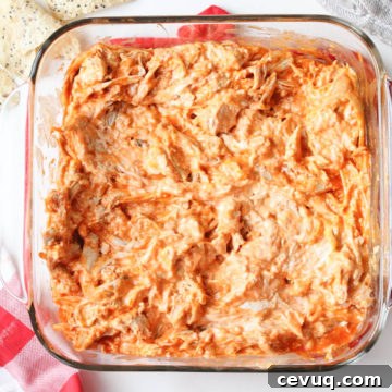 Gluten-Free Buffalo Chicken Dip Recipe for Game Day Snacks 7 glass container of creamy buffalo chicken dip with chips