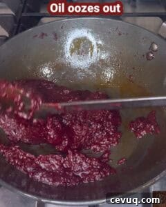 Cranberry oorugai with oil oozing out during cooking process.