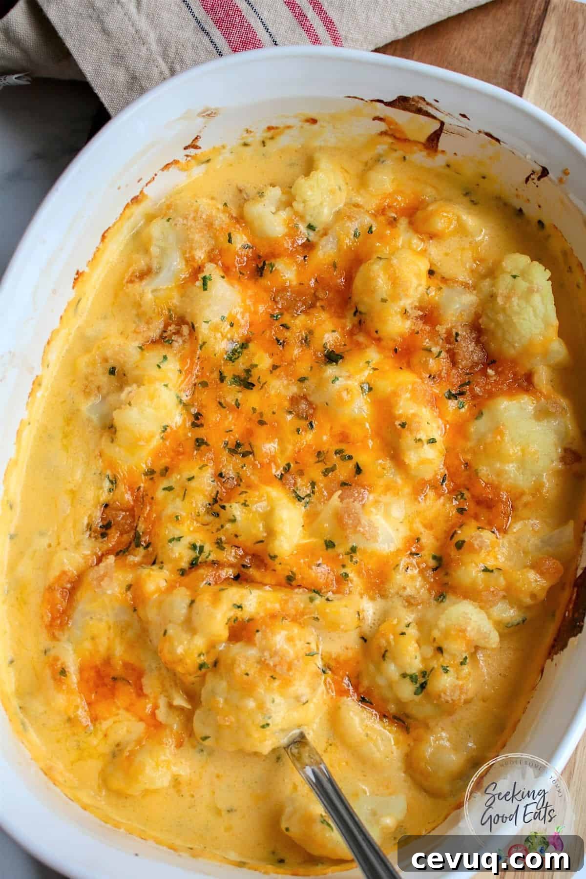 Creamy Cauliflower Mac & Cheese Casserole 2 Baked Cauliflower cheese in a white oval baking dish.