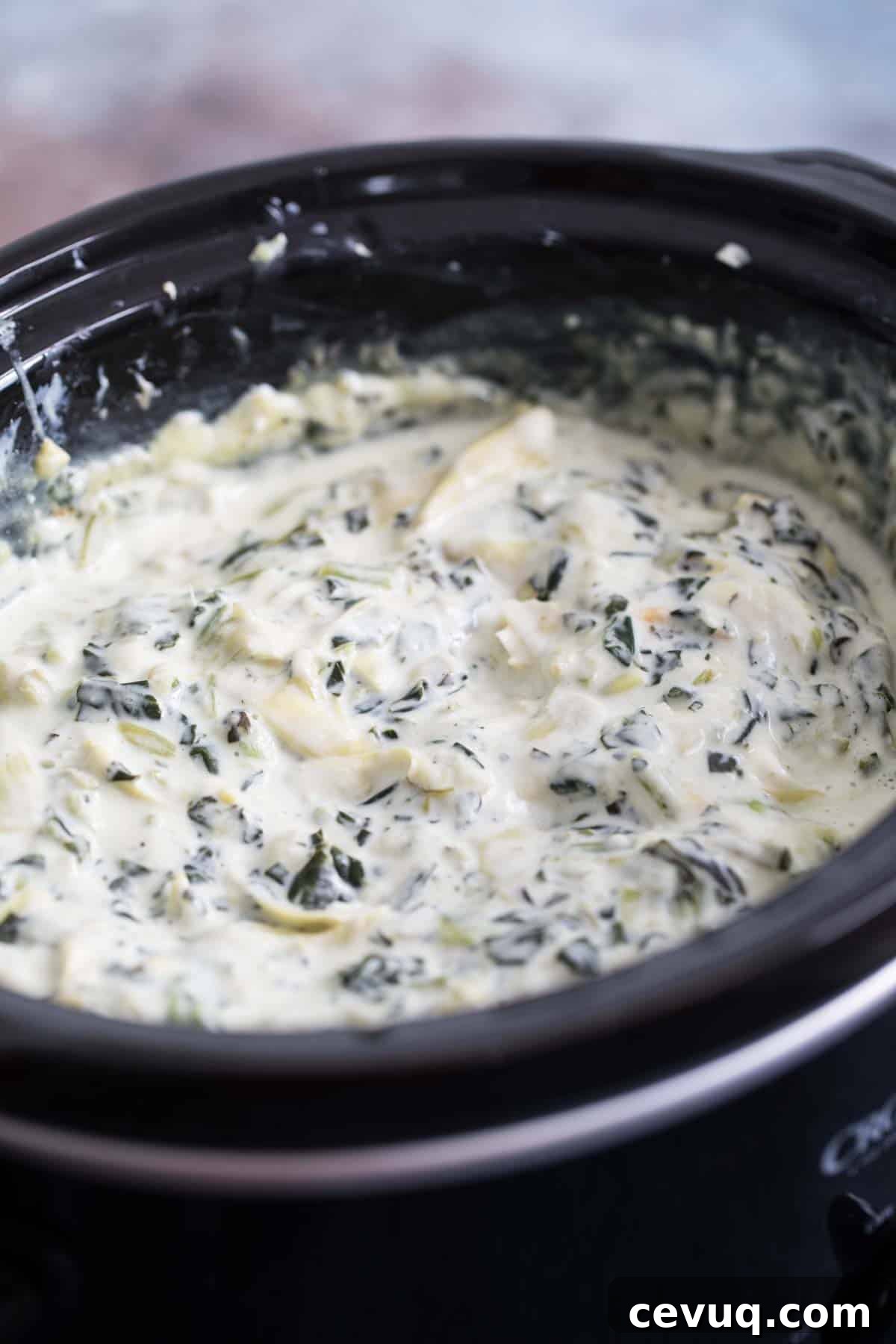 crockpot full of spinach artichoke dip