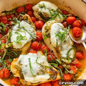 chicken caprese in a pan with cherry tomatoes