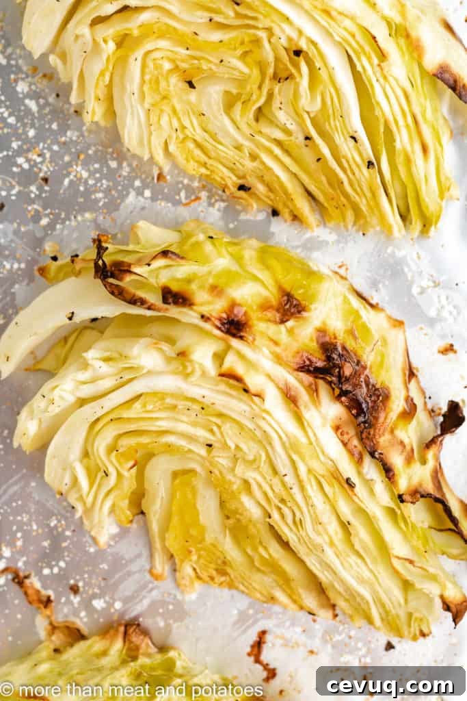 Roasted cabbage wedge on a baking sheet.