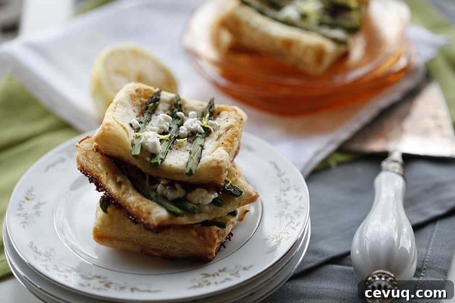 A stack of asparagus pastries on a plate.