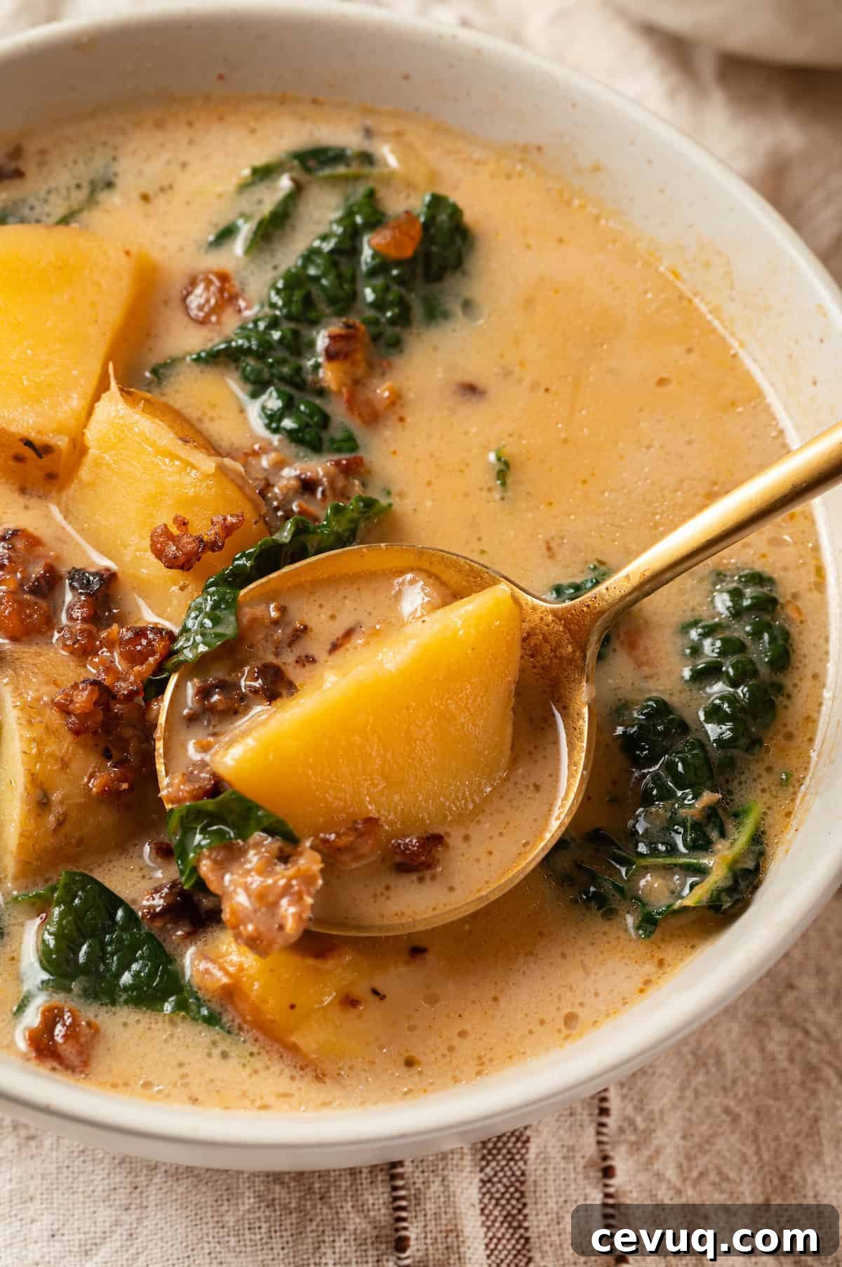 Spoonful of zuppa toscana in bowl