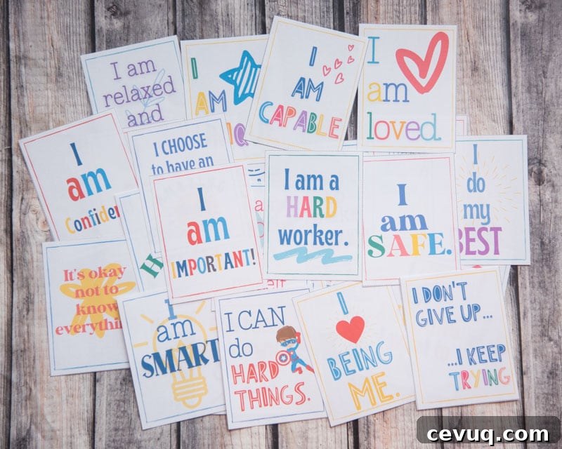 printed affirmations cards for children laid out on a wooden surface