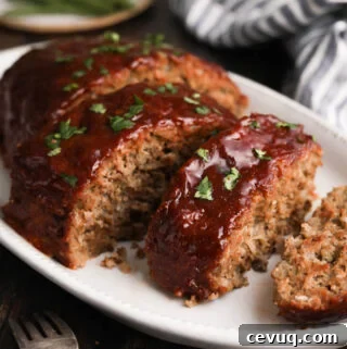 A photo of the Best Meatloaf Recipe with a peppery ketchup and brown sugar glaze on a serving platter