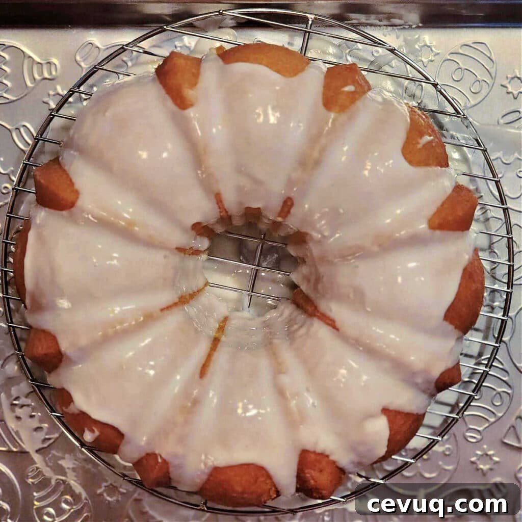 Lemon Pound Cake Recipe for True Lemon Lovers 7 An overhead shot of a Bundt cake with fresh glaze poured over it.