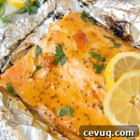 grilled salmon nested in foil with lemon slices laying on top