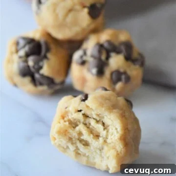 No-Bake Energy Bites Recipe for Quick, Protein-Packed Snacks 12 No bake energy bites, one with a bite taken out of it.