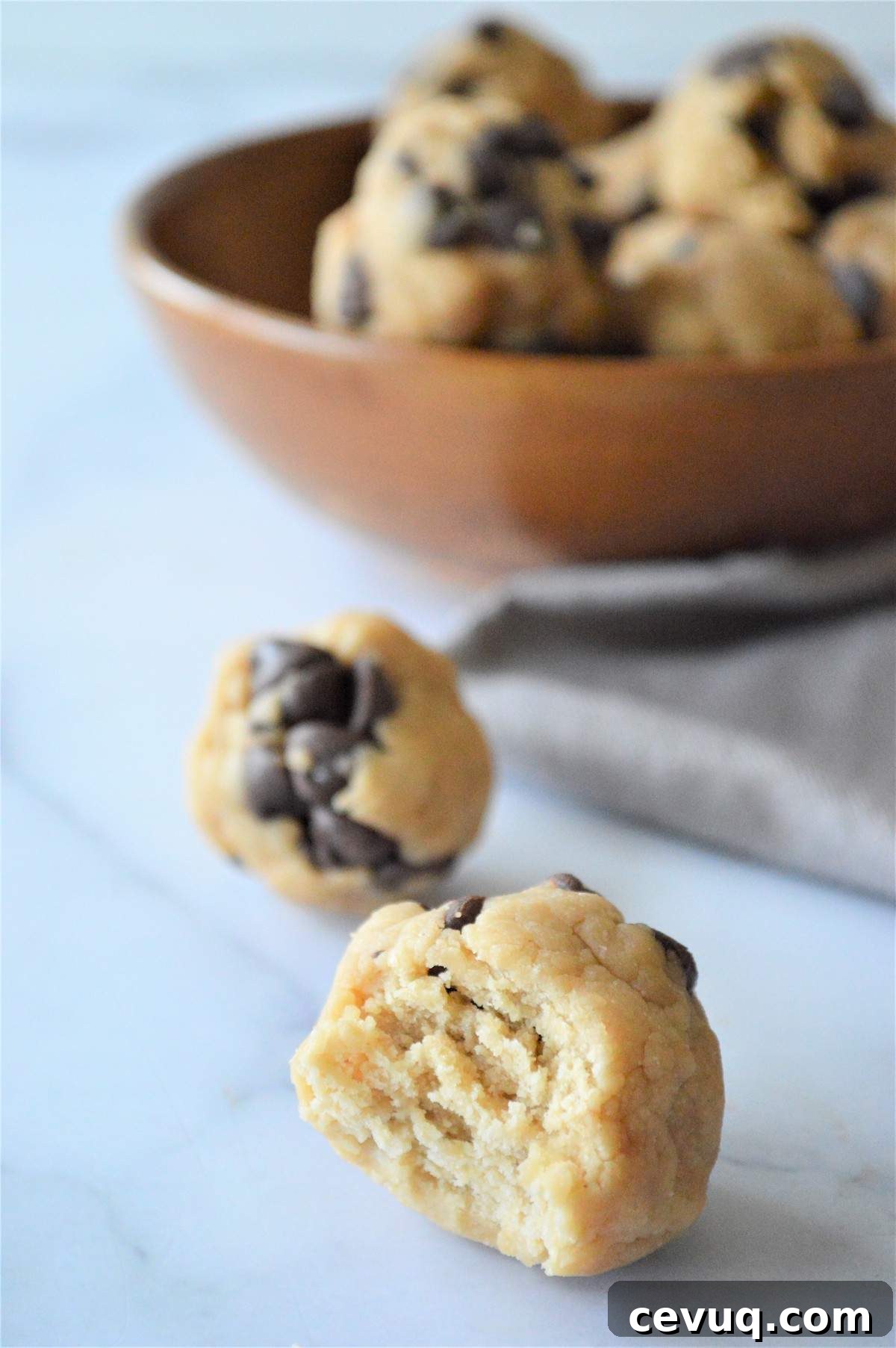 No-Bake Energy Bites Recipe for Quick, Protein-Packed Snacks 10 No bake energy bites in front of a bowl of no bake energy bites.