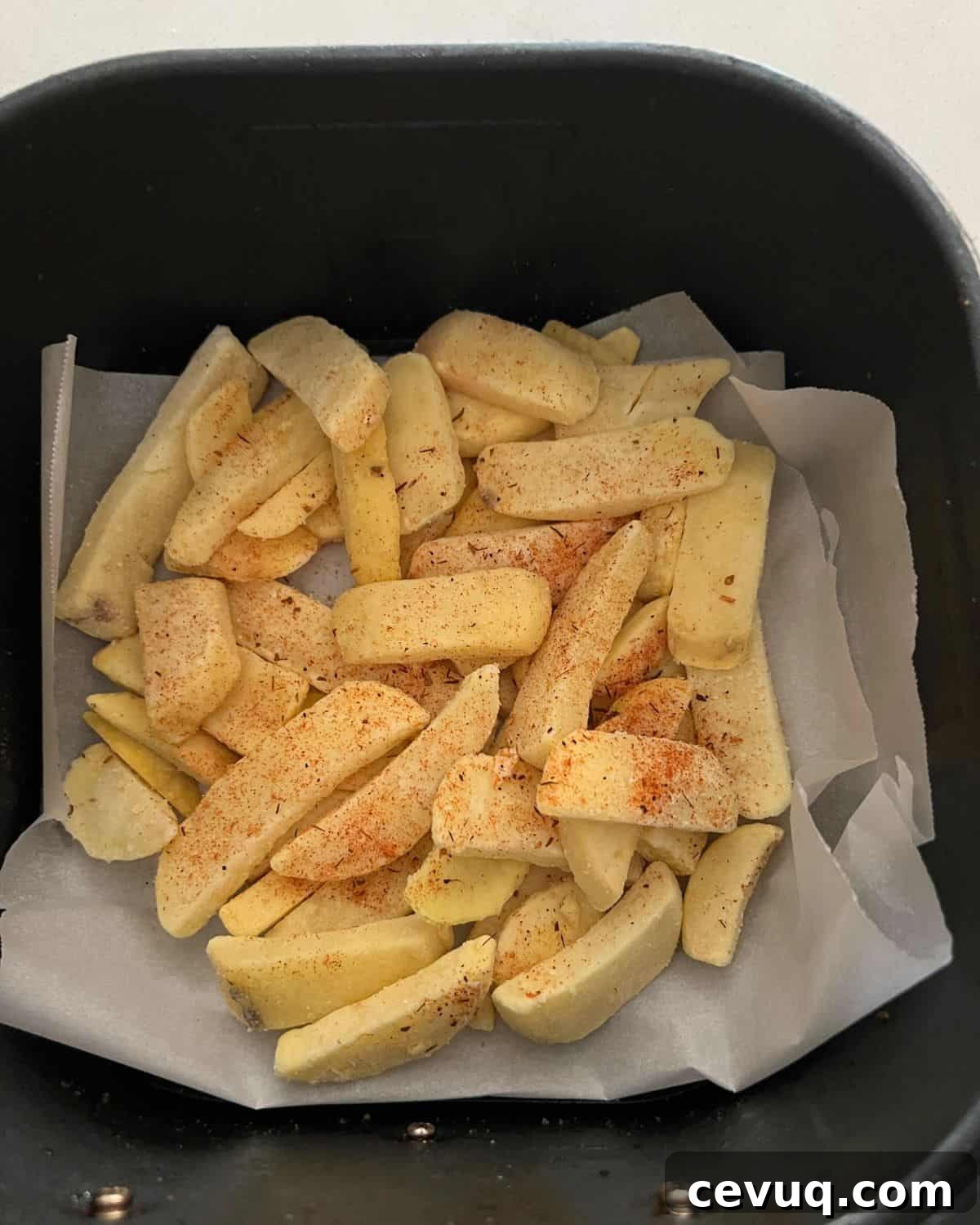 Seasoned french fries in air fryer.