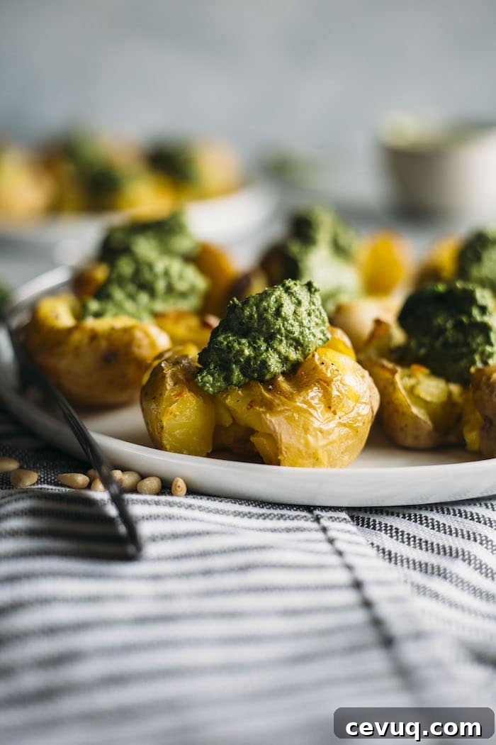 Pesto Smashed Potatoes | CRISPY smashed potatoes topped with a healthy kale pesto, aka the perfect side dish | thealmondeater.com