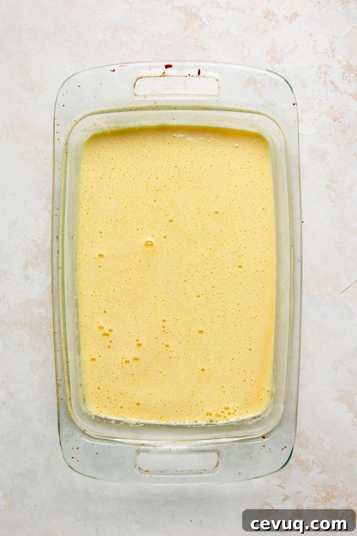 Egg and cottage cheese mixture poured into baking dish before baking.