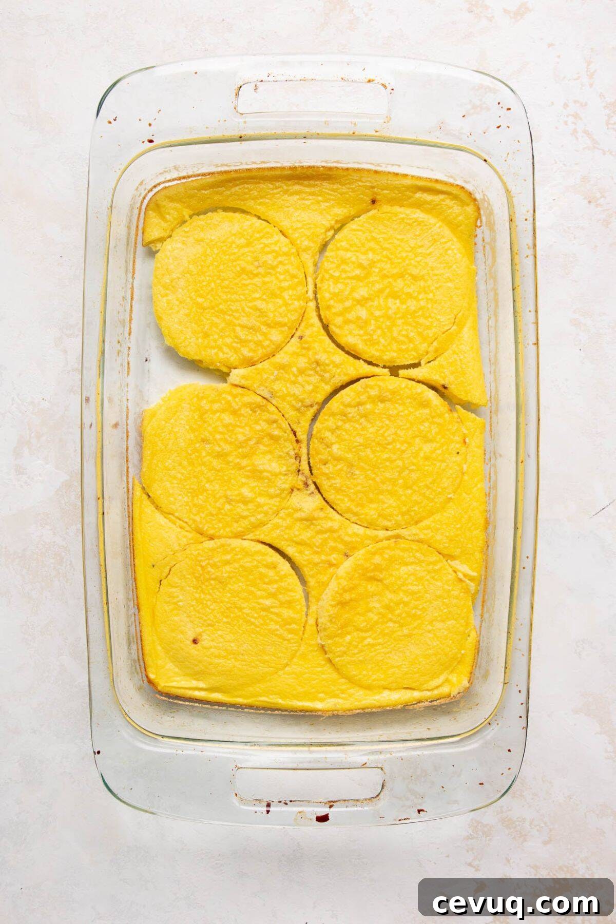 Fluffy baked egg slab cut into rounds for breakfast sandwiches.