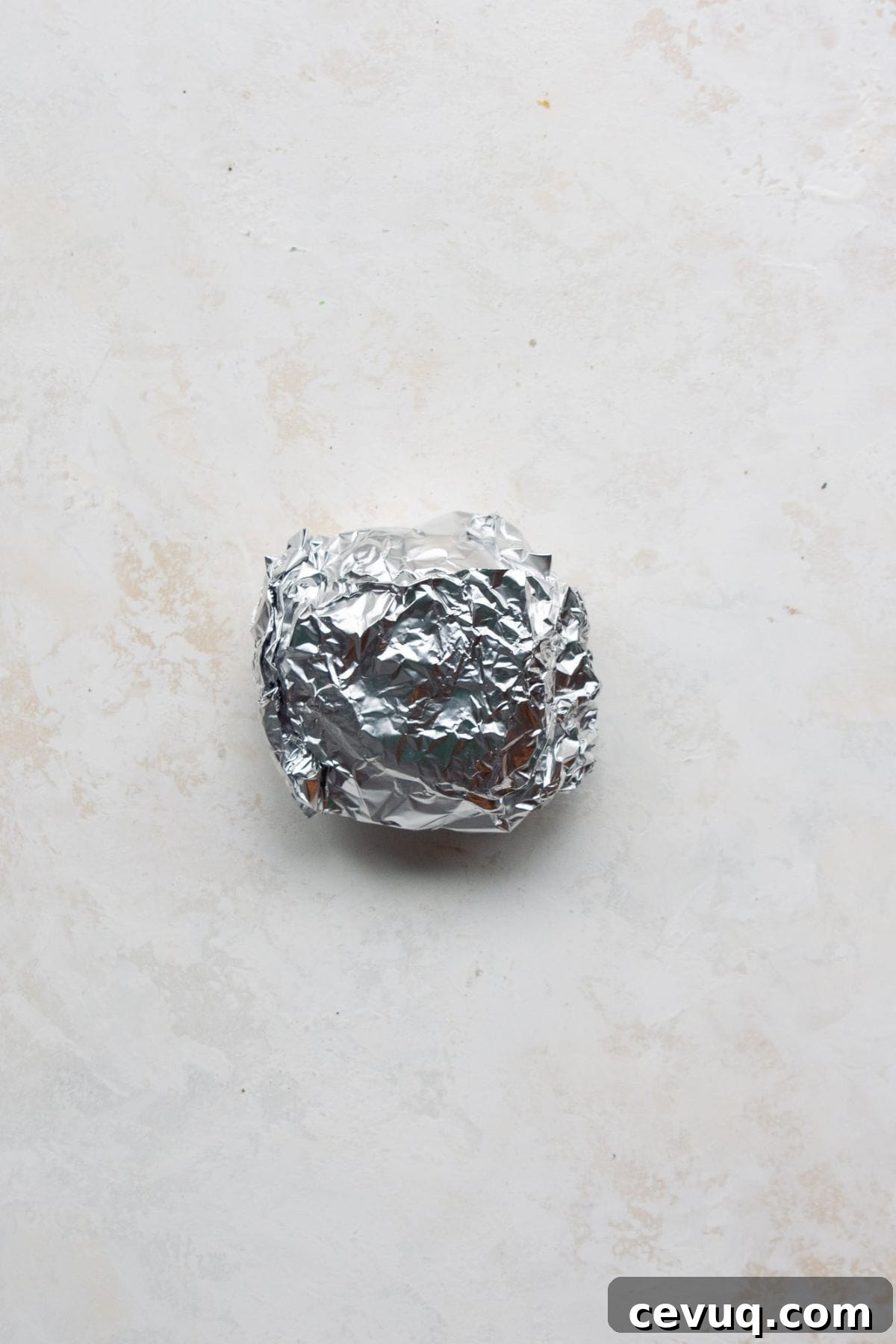 Breakfast sandwich wrapped in foil for freezer meal prep.