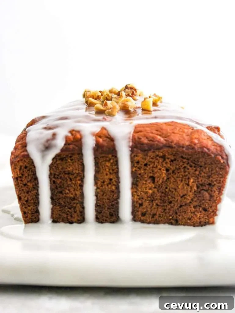iced pumpkin quick bread topped with walnuts side view
