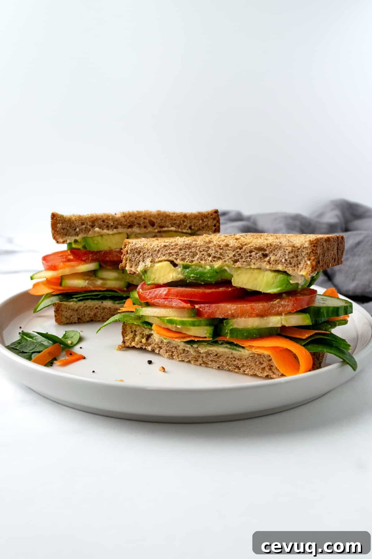 Hummus Cucumber Sandwich on a white plate.
