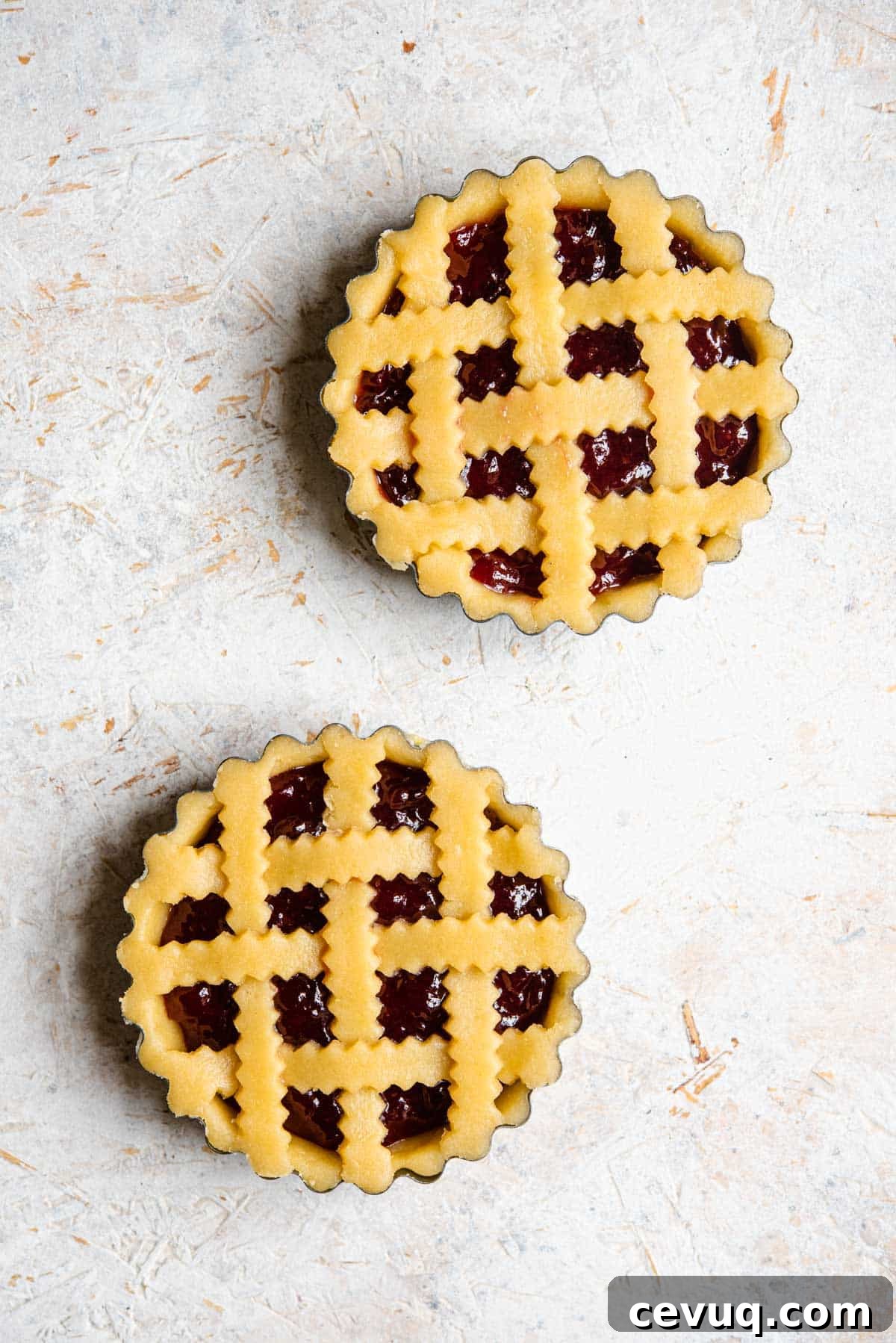 An overhead shot of two shortcrust pastry tarts before being cooked