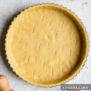 A square photo of raw sweet shortcrust pastry in a tart case