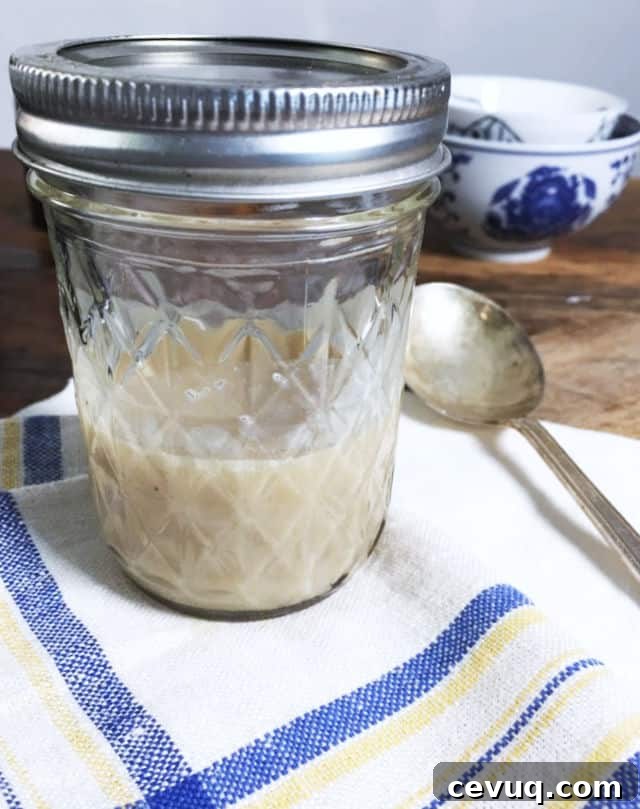 How to Save and Store Bacon Grease for Cooking and Flavor 2 A jelly jar half full of bacon grease on a blue and white napkin