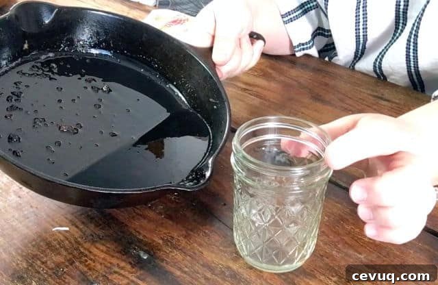 How to Save and Store Bacon Grease for Cooking and Flavor 4 an empty jelly jar and black cast iron skillet