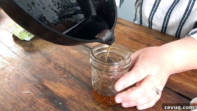 How to Save and Store Bacon Grease for Cooking and Flavor 5 pouring the bacon grease into the jelly jar