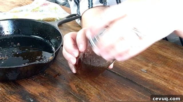 How to Save and Store Bacon Grease for Cooking and Flavor 6 putting the lid on the jelly jar with bacon grease for how to save bacon grease