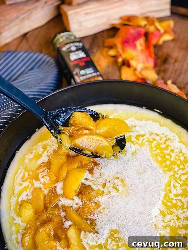 Adding peaches to the cobbler batter