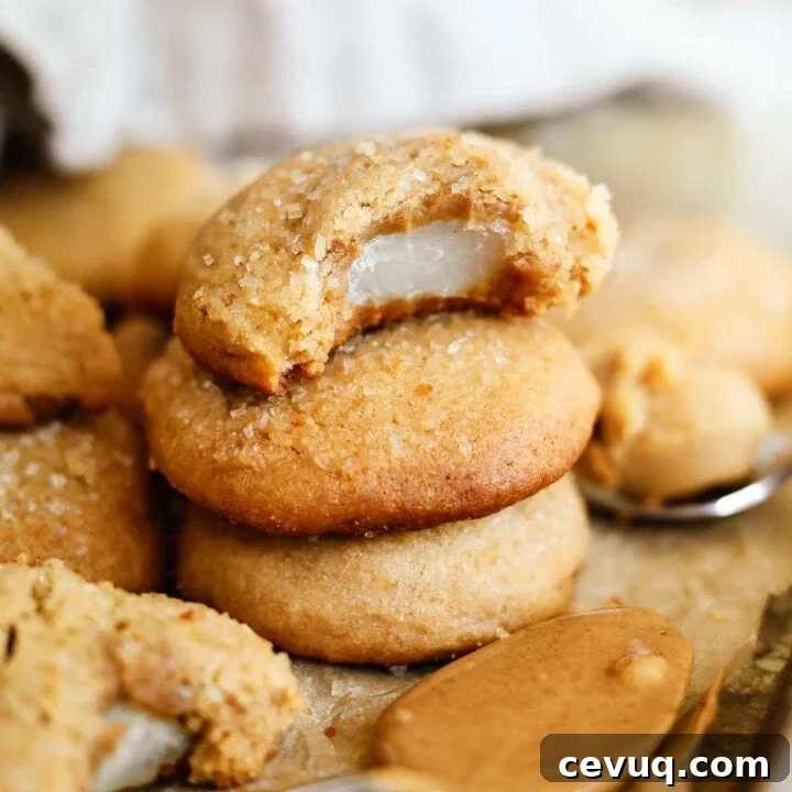 Mochi-stuffed peanut butter and miso cookies stacked with a bite taken out.