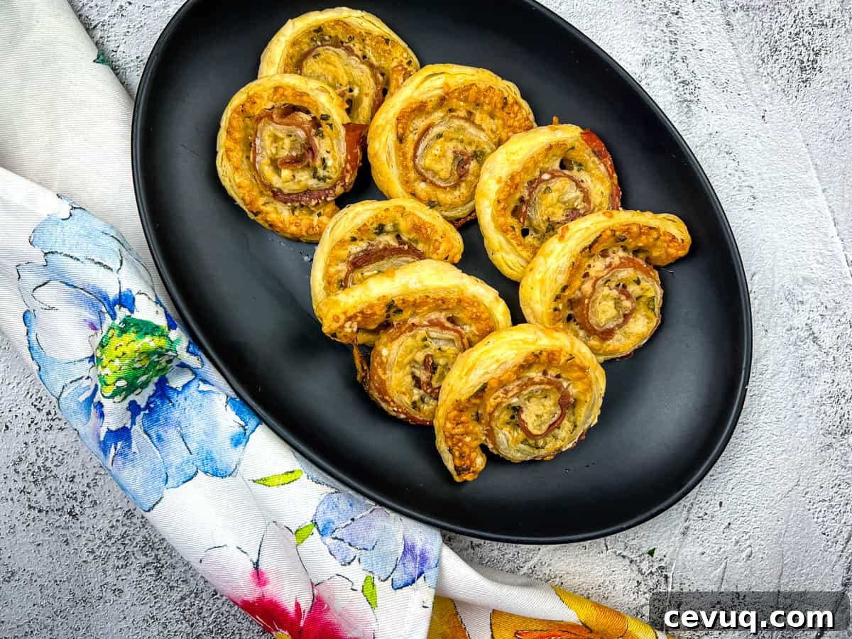 A plate of Prosciutto & Parmesan Puff Pastry pinwheels.