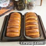 two loaves of condensed milk bread placed on a baking tray
