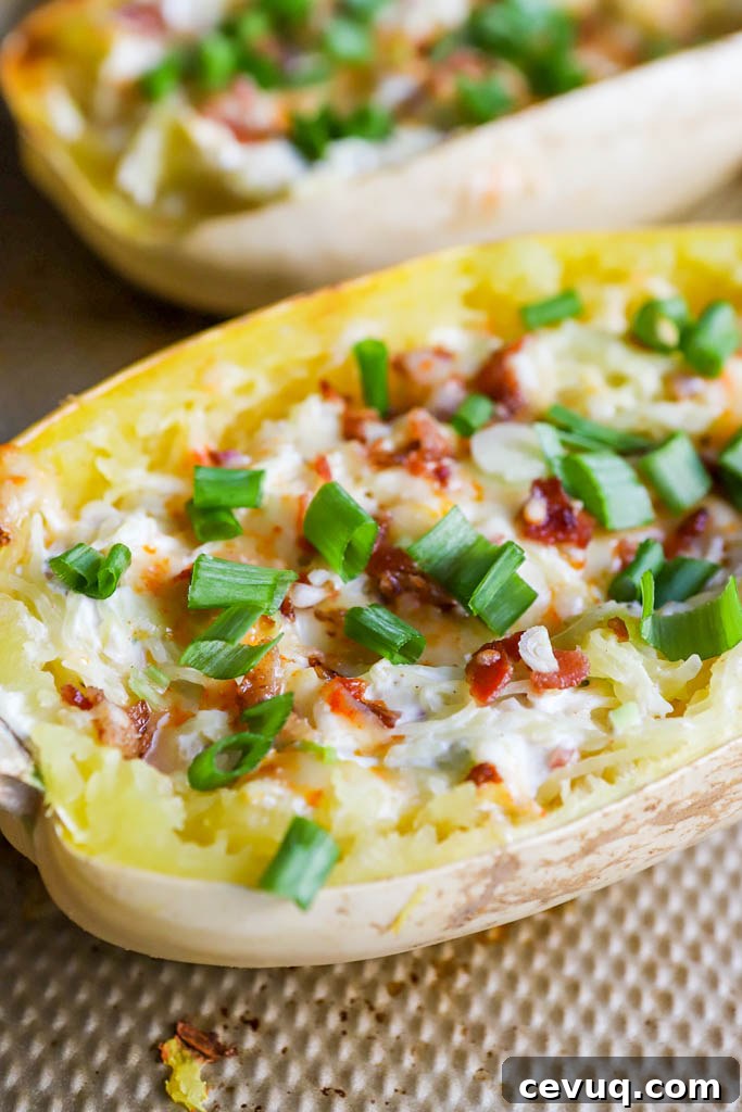 Jalapeno Popper Stuffed Spaghetti Squash with fresh green onions on baking sheet
