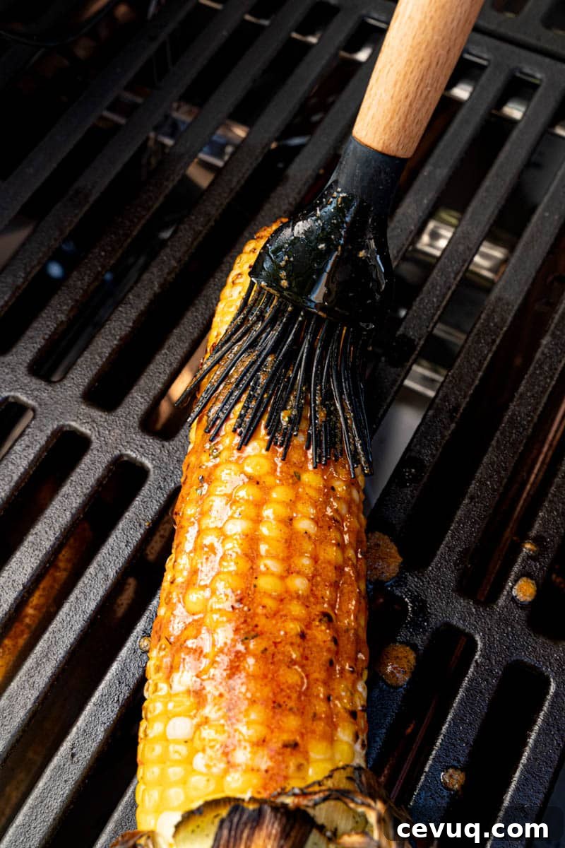 Basting the corn with the cajun butter on the grill