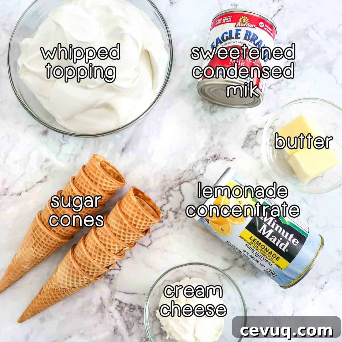 Overhead shot of ingredients- whipped topping, sweetened condensed milk, butter, lemonade concentrate, cream cheese, and sugar cones.