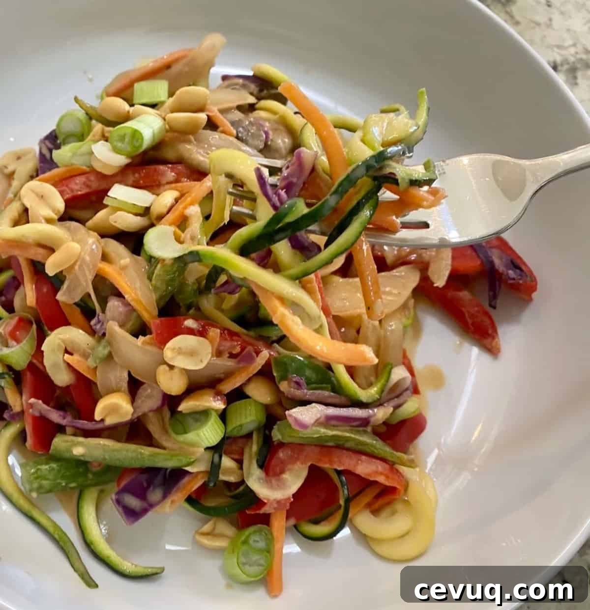 Zoodle Pad Thai on a plate on the table with a fork 