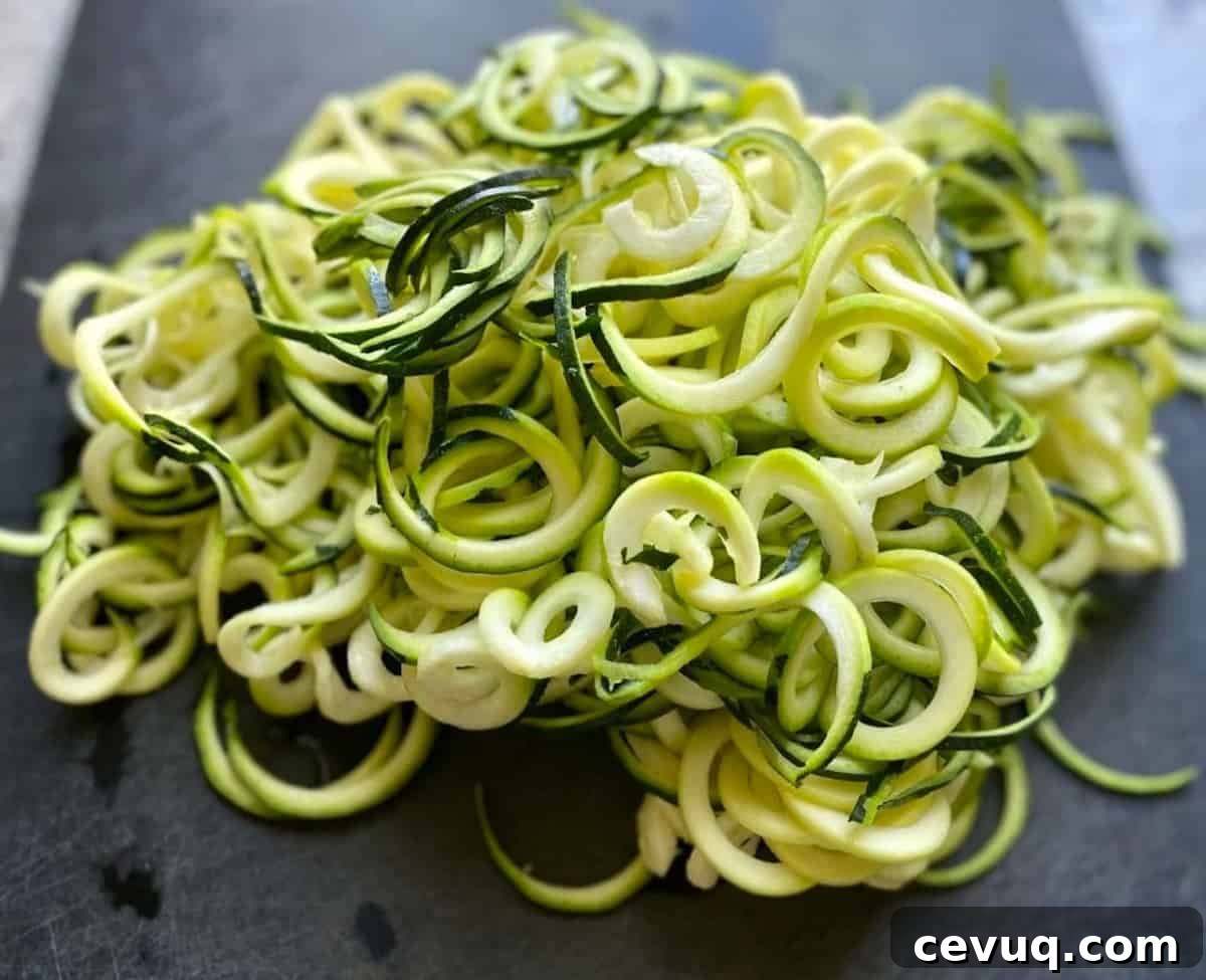 Spiralized zucchini for zoodle Pad Thai on a cutting board